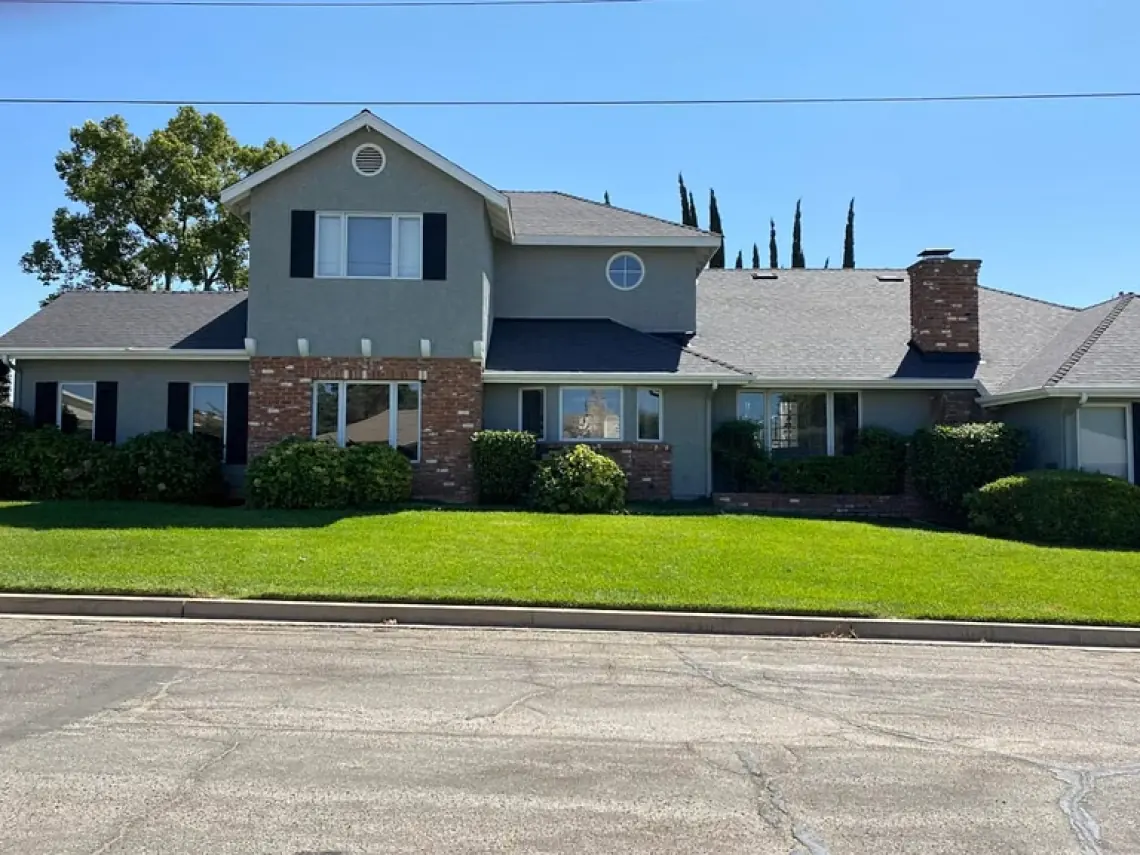 Gray shingle roof on a two-story home from Team All Star Construction’s residential portfolio